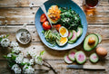 A clock next to a healthy meal illustrating timed eating