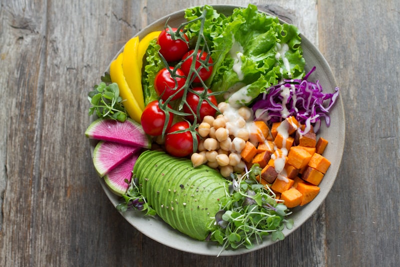 A colorful overhead photo of freshly prepared plant-based salads