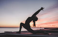 A trainer doing a yoga pose at home