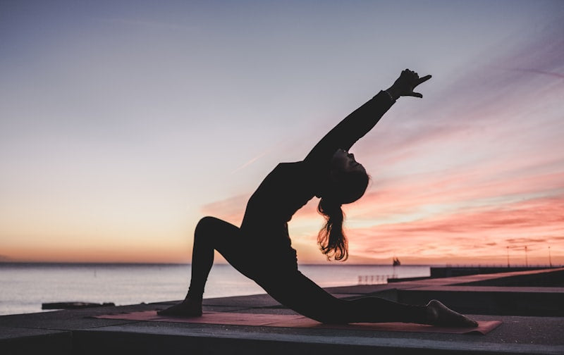 A trainer doing a yoga pose at home